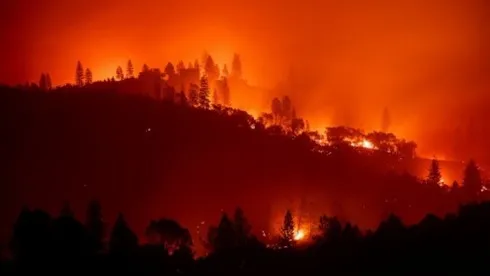 A fire burning on top of a mountain.