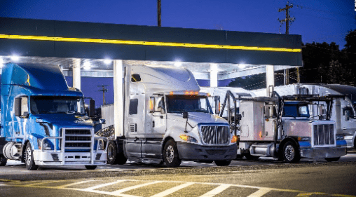 A truck is parked at the gas station.